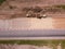 Road Construction Site near the highway with machinery, bulldozer, excavation from above. 4K video, top down view.