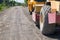 Road construction vehicle on the rough rural road.