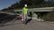 Road construction worker show stop gesture and put traffic cone