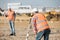 Road construction workers using measuring device on the field