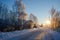 Road covered with snow in russian village in the sunset in wintertime