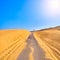 A road crossing an arid dune terrain