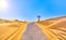 A road crossing an arid dune terrain