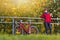 Road Cycling Concepts. Winsome Caucasian Female Cyclist In Full Outfit Posing With Road Bike At Prop Outdoors Against Autumn