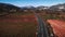 Road cyclists riding on road through vineyards at winter sunny day. Active sport