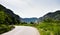 Road by the Danube river, forests and mountains