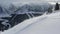 The road descends like a streamer. Landscape with snow-capped mountain peaks. .