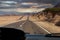 Road through the desert. view from the window of a tourist bus