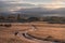 Road dirt mountains dawn trees hills clouds sky