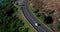 Road, drone view and driving for travel, highway or journey along the coast or countryside. Aerial view of car traveling