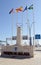 Road entrance to Port of Malaga, Spain, with flags