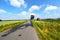 Road through fields that are watered by sprinklers in the Lueneburger Heath, Germany