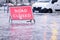 Road flood closed sign under deep water during bad extreme heavy rain storm weather in UK