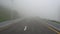 The road in the fog. First-person view, walking on the road.