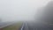 Road with fog in the morning. Misty highway.