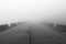 Road in the Fog. Thick Fog and Empty Road. Mystic Foggy Road. Place for Text. The Etna volcano. The island of Sicily, Italy