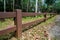 Road and forest brown fence.