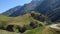 Road through the french pyrenees in the morning sun with clouds rising in the background