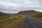 A road going around the mountains in Iceland