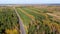 Road going through forest landscape, aerial view