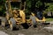 Road grader blade moving earth