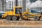 Road grader at the construction site. Powerful construction machine for ground leveling and excavation. Close-up. Professional