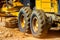 Road grader working at construction site for maintenance and construction of dirts and gravel road. Yellow motor grader. Heavy