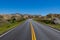 Road, grassy meadows, and colorful peaks of Badlands National Park