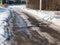 Road in a holiday village, frozen track, ice, early spring 2021