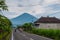 The road with houses in Amed. Views of mount Agung in cloudy weather. Bali