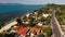 Road and houses on seashore. Drone view of main road and coastal cottages on Ko Samui Island on sunny day in Thailand. Bang Po