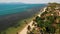 Road and houses on seashore. Drone view of main road and coastal cottages on Ko Samui Island on sunny day in Thailand. Bang Po