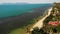 Road and houses on seashore. Drone view of main road and coastal cottages on Ko Samui Island on sunny day in Thailand. Bang Po