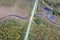 road intersecting blue river among autumn yellow forests, bogs