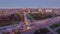 Road intersection with reconstructed tram tracks aerial panoramic day to night timelapse.