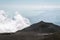 The road and jeep truck above clouds on Mountain Etna volcano in Sicily, Italy. The biggest active volcano in Europe