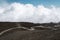 The road and jeep truck above clouds on Mountain Etna volcano in Sicily, Italy. The biggest active volcano in Europe