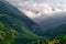 The road in Karmadon Gorge and river Genaldon summer view. The Caucasus Mountains