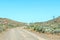 Road landscape, with uneven roadway sign, on historic Postal Route