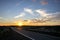 Road, lava field and a sunset, Lanzarote, Spain