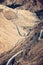 Road leading through dry and cold rough landscape of high Atlas mountains