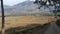 The road leading from the middle of the fields to the village settled at the bottom of the hill