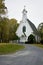 Road leading to beatiful little white church in th