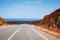 Road leading to horizon trough the dusty landscape of Boa Vista island.