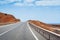 Road leading to horizon trough the dusty landscape of Boa Vista island.