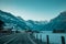 Road leading to Kandersteg in early morning in cold temperatures, majestic mountain panorama over the road