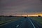 Road Leading to view of the Texas wind turbine farms in the colorful sunset showing