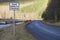 Road liable to flooding road safety sign by river in rural countryside