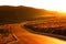 The road in the light of the autumn sunset on the Plateau of the Bucegi mountains, Romania, Europe.