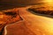 The road in the light of the autumn sunset on the Plateau of the Bucegi mountains, Romania, Europe.